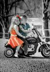 Девочка и мальчик на детском мотоцикле