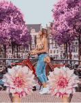 Девушка на велосипеде и хризантемы
